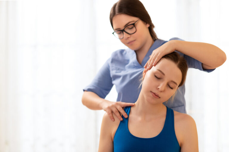 Female physiotherapist or a chiropractor adjusting patients neck. Physiotherapy, rehabilitation concept. White background front view with copy space